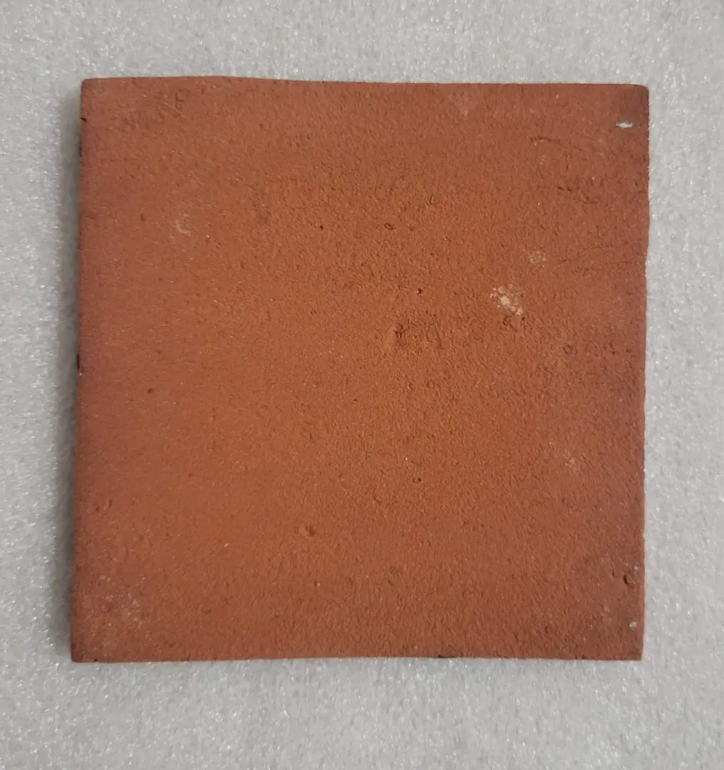 Square red brick on light background.