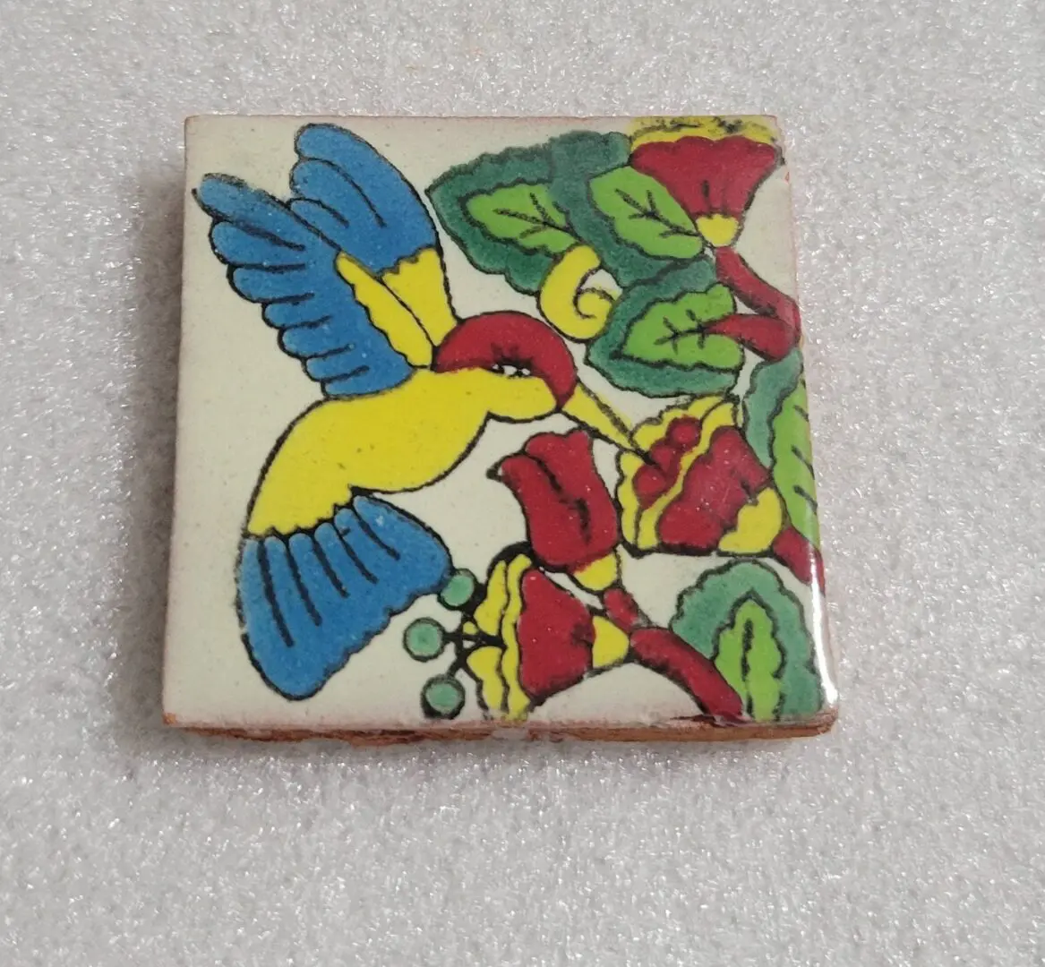 Colorful bird on a decorative ceramic tile.