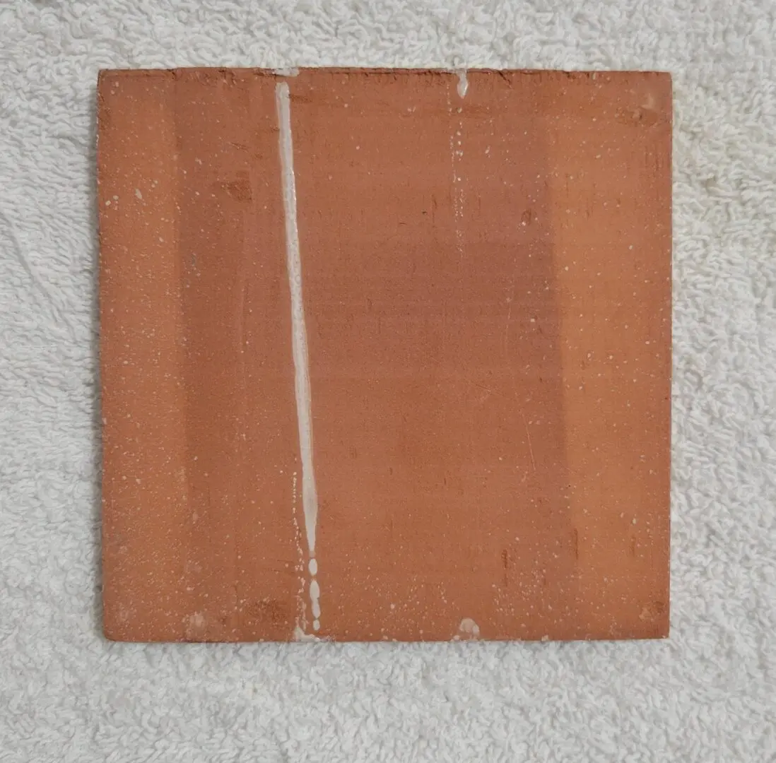 Square terracotta tile with vertical glaze drip