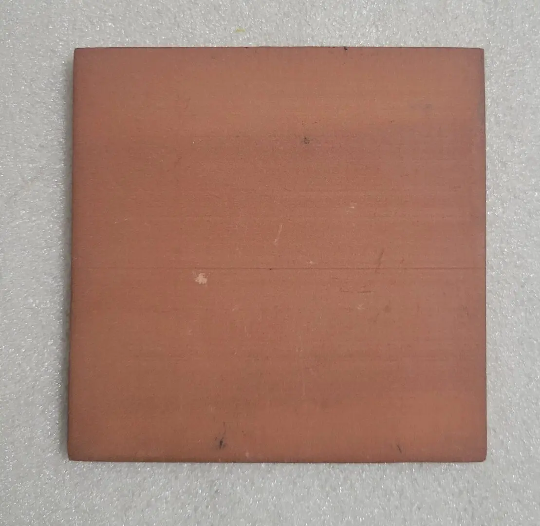 A plain square tile with a muted reddish-brown color.