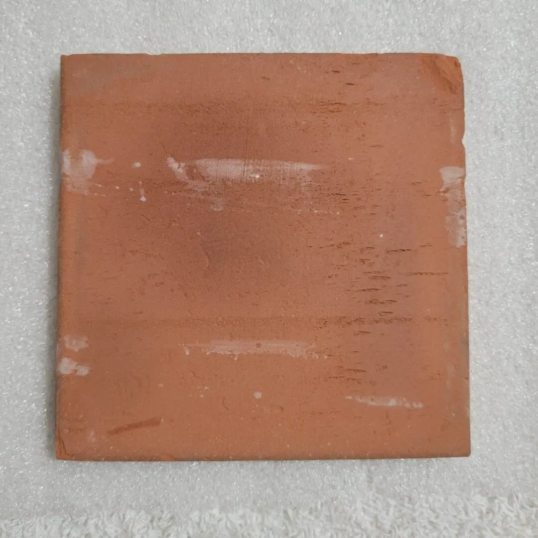 Brown square tile on white background.