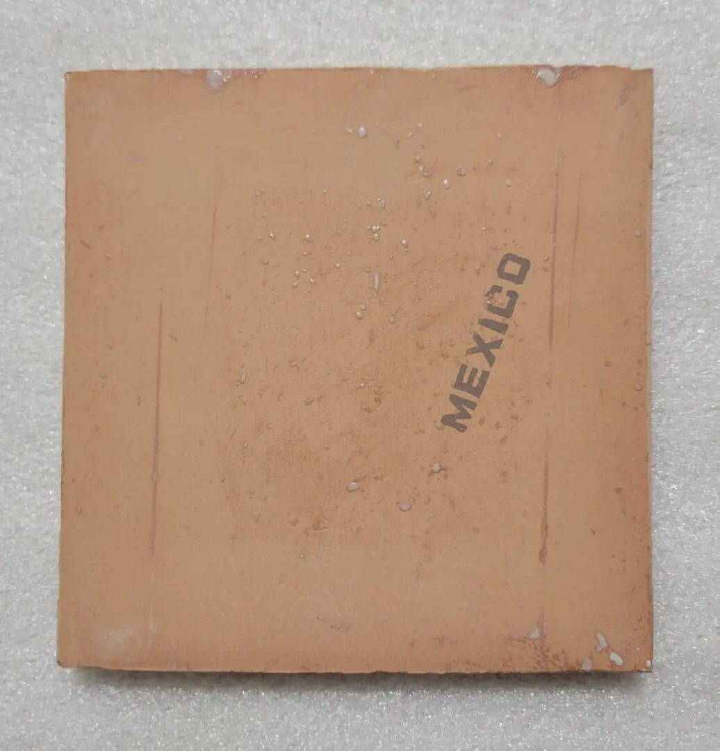 Terracotta tile with "Mexico" stamped on it.