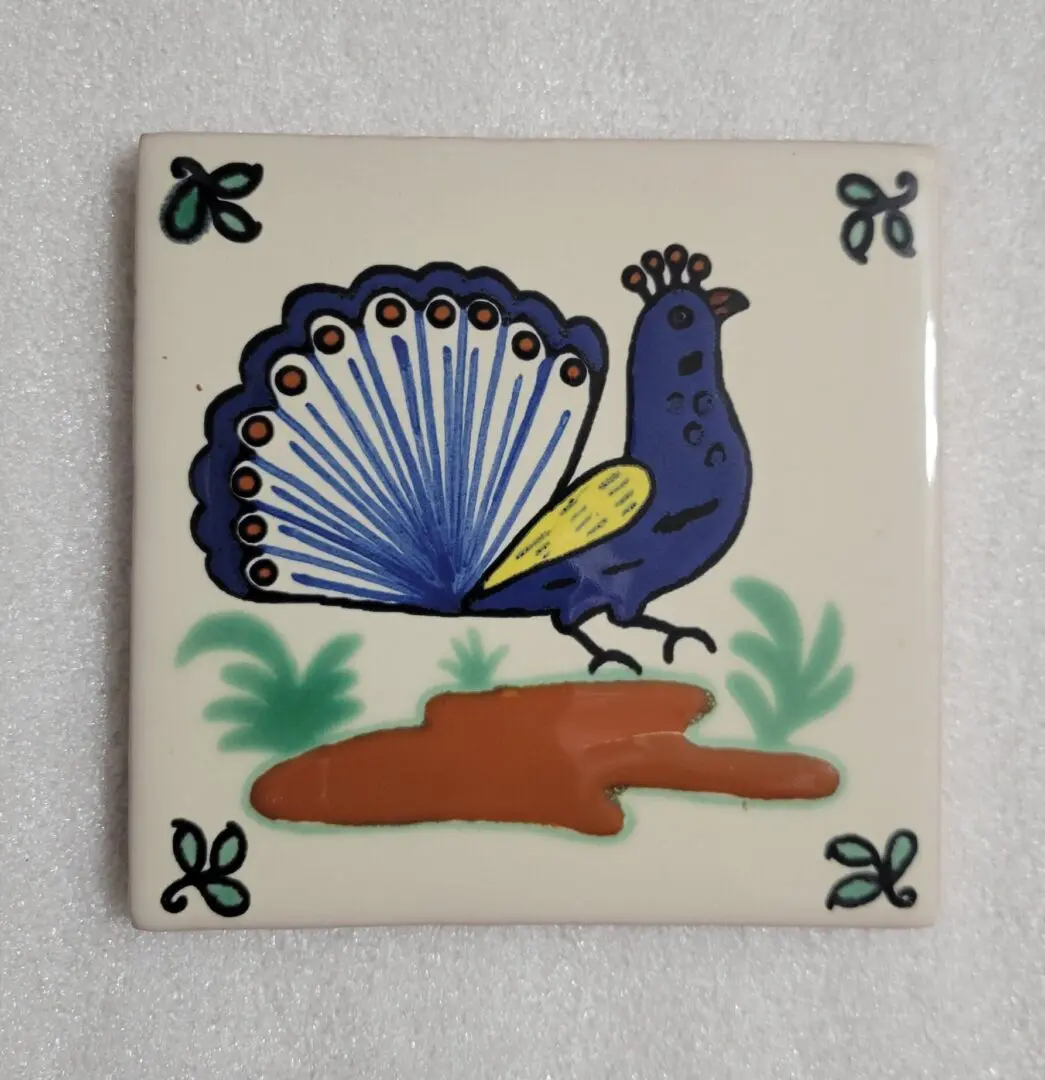 Colorful bird illustration on ceramic tile.