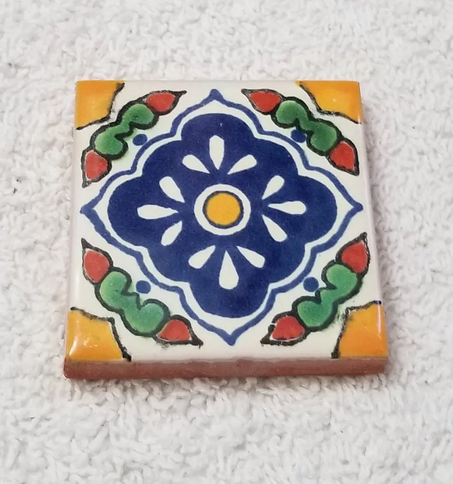 Hand-painted ceramic tile with blue floral medallion