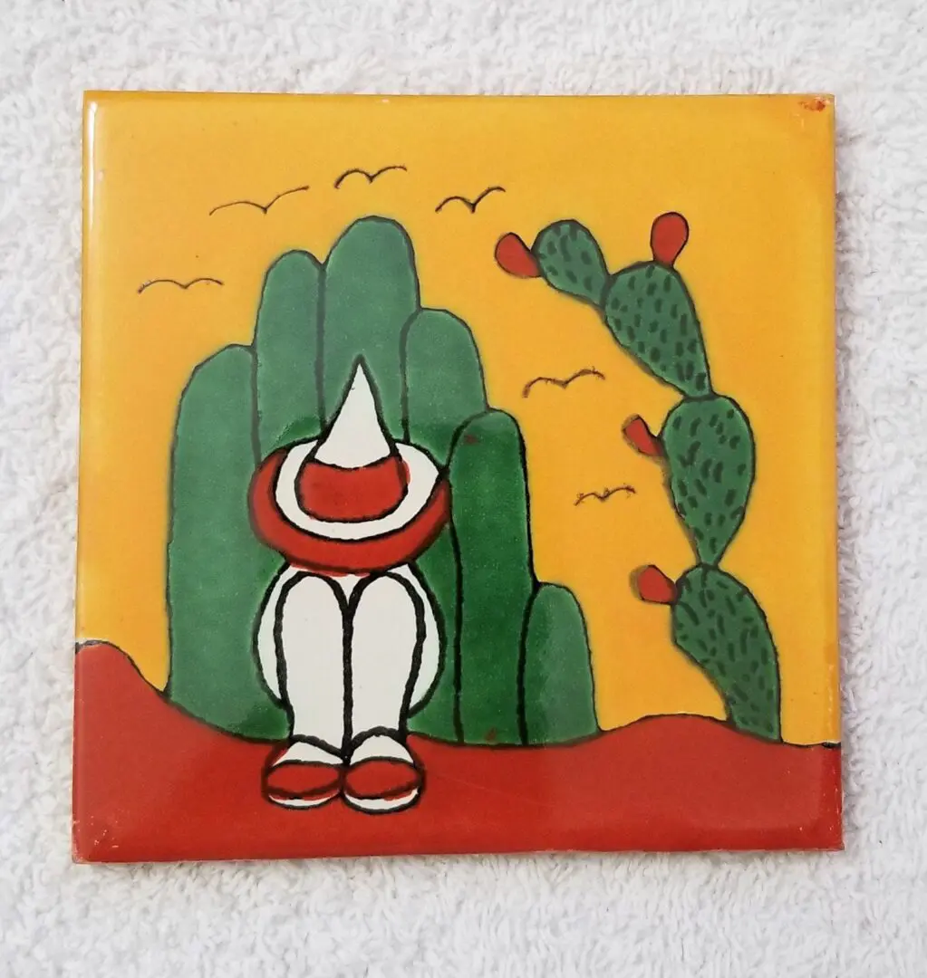 Mexican-themed art with cactus and figure.