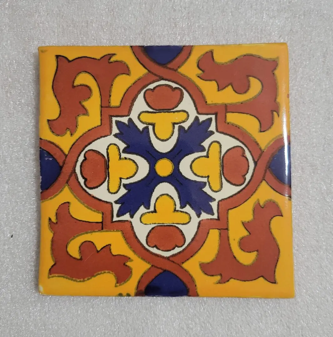 Colorful, patterned ceramic tile on white background.
