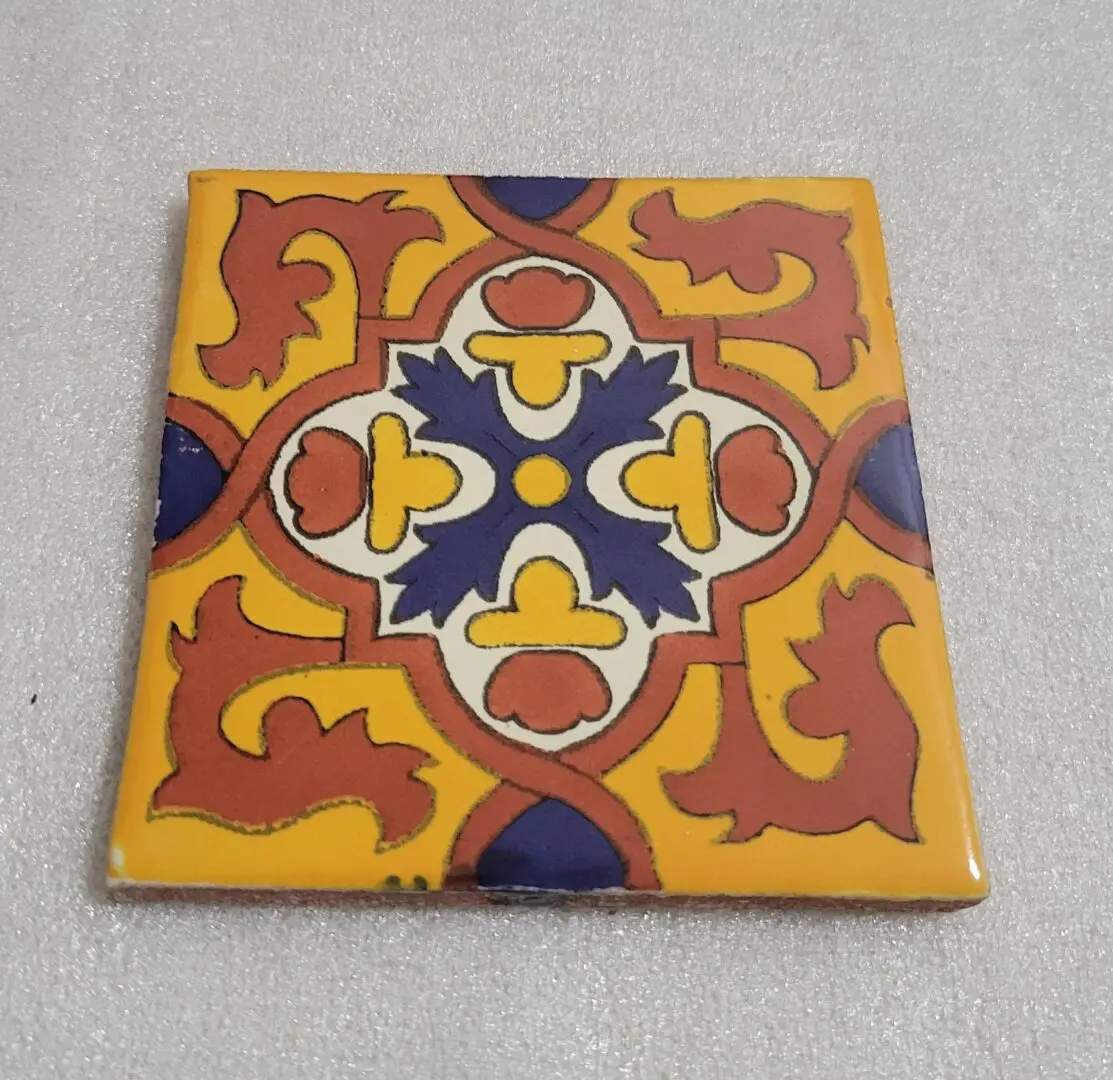 Colorful decorative ceramic tile with intricate pattern.