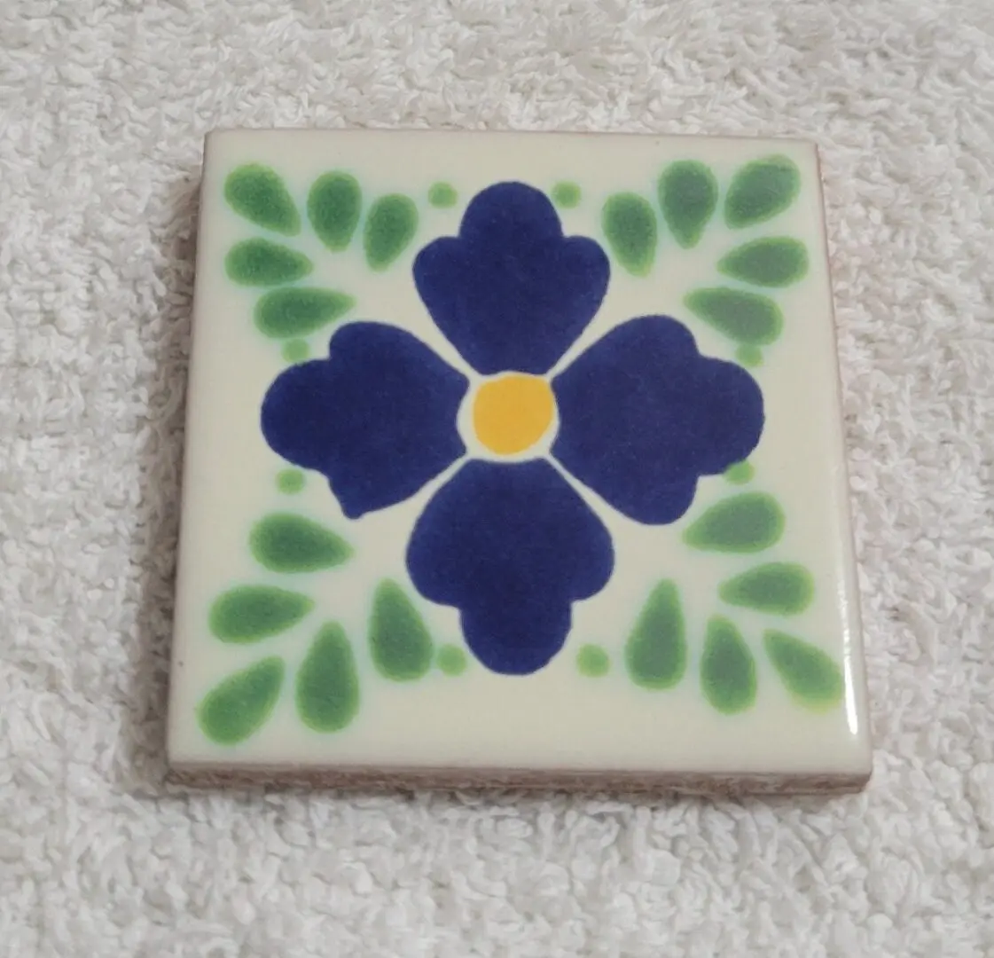 Blue floral ceramic tile with green leaves