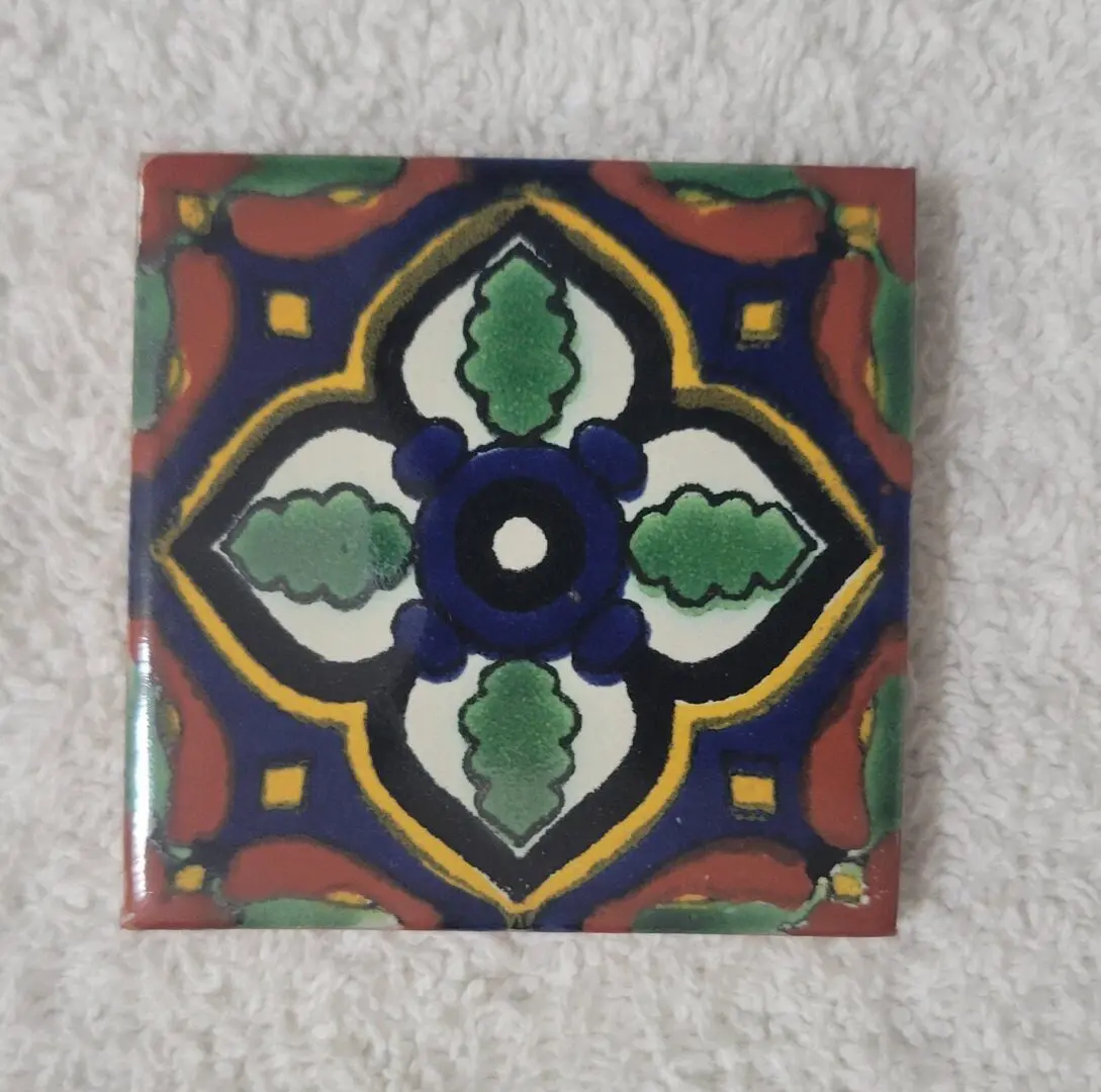 Decorative ceramic tile with colorful geometric pattern.