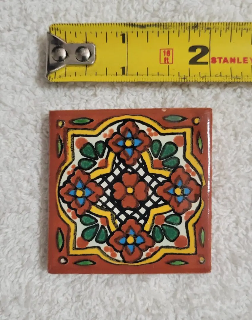 Small colorful decorative ceramic tile with floral pattern