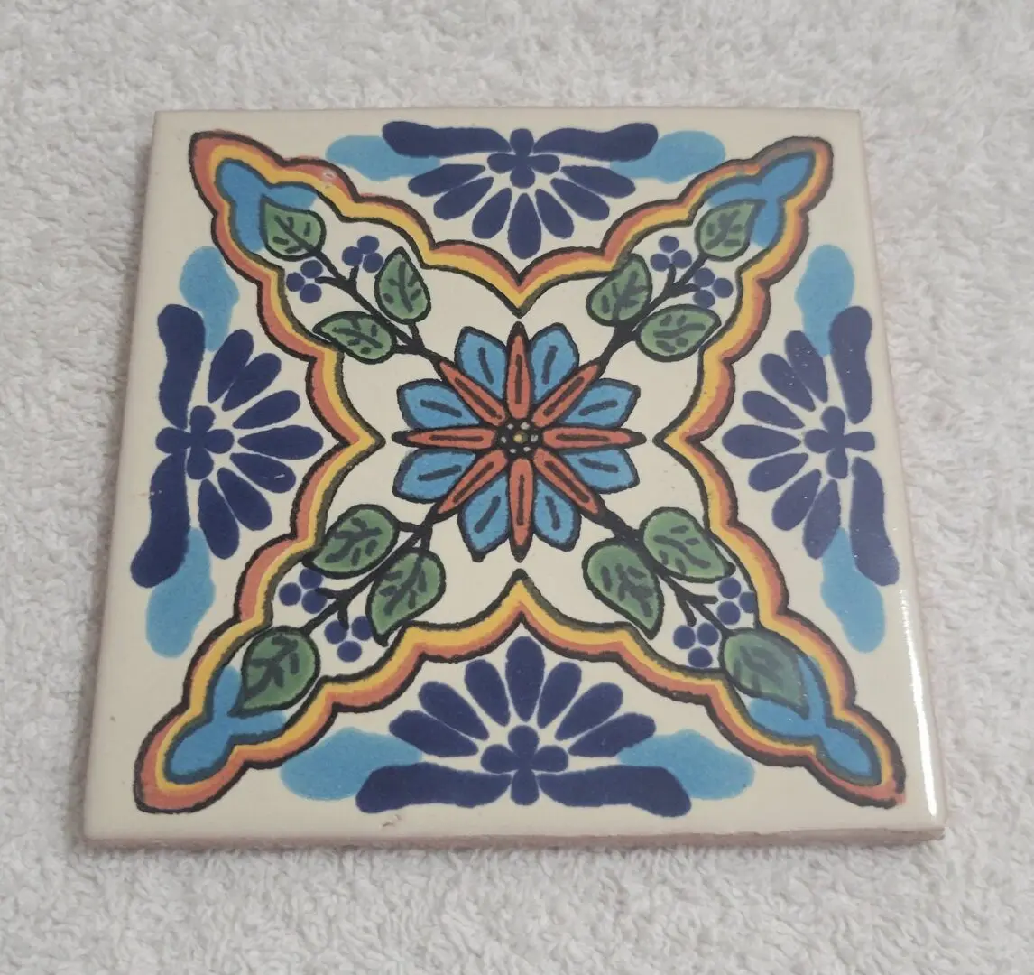 Hand-painted decorative ceramic tile with floral motif