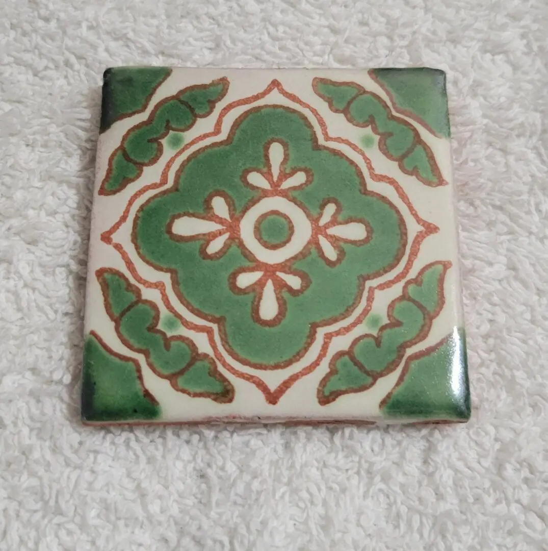 Green and white decorative ceramic tile design.