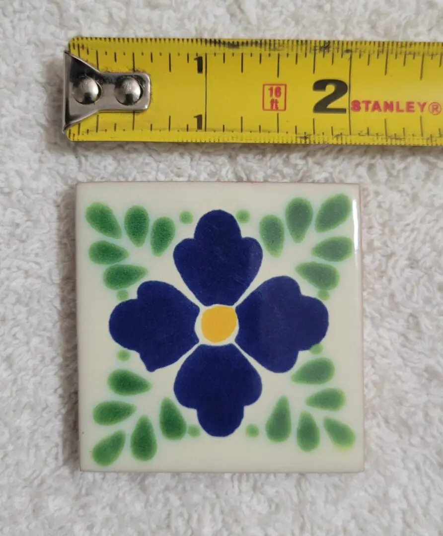 2-inch blue floral ceramic tile on towel