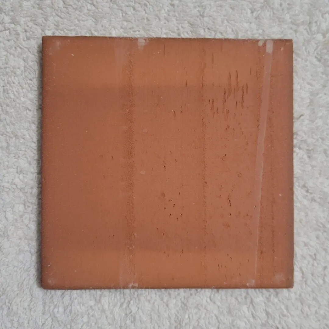 square terracotta ceramic tile on towel