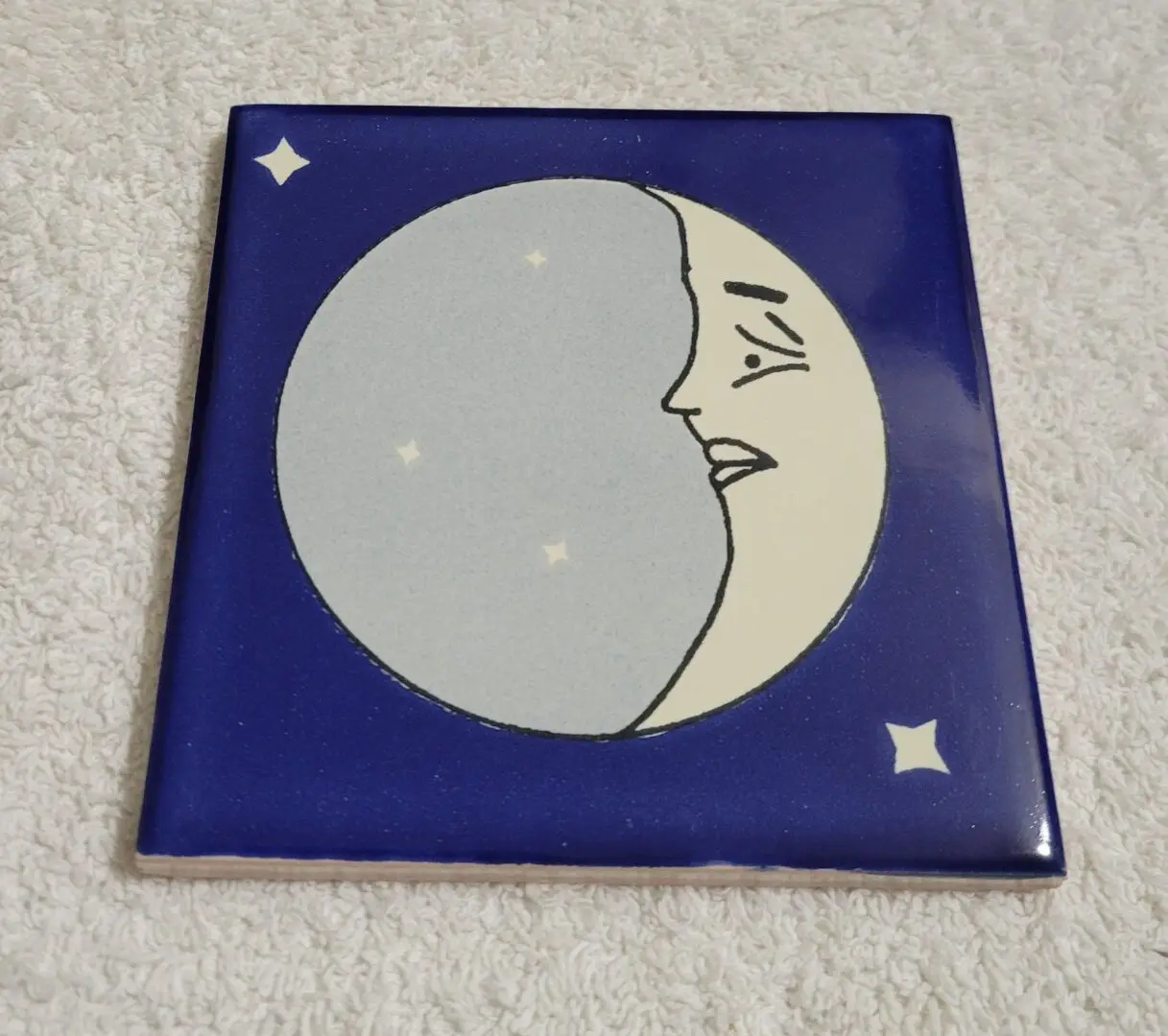 Tile with moon and stars design.