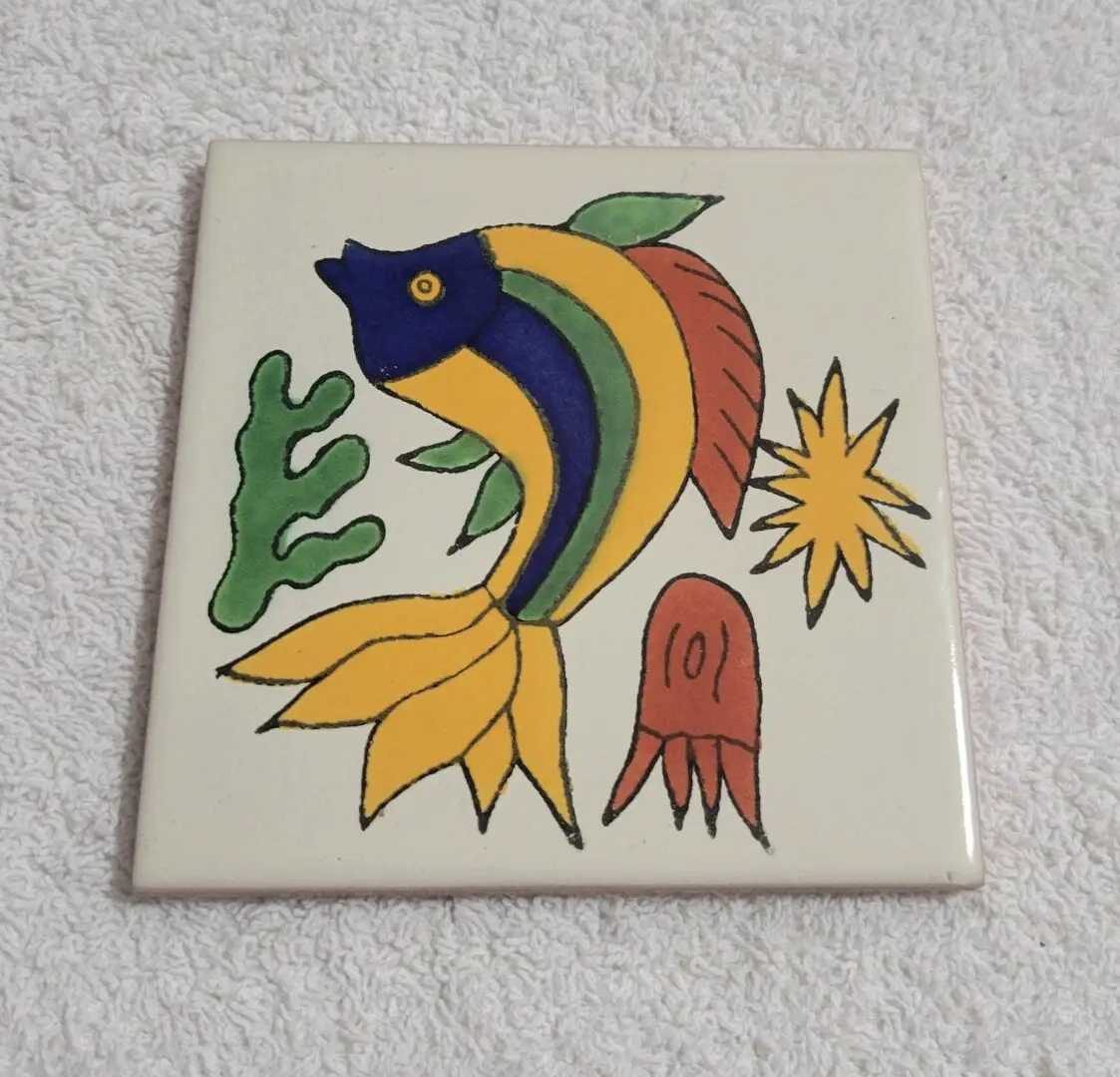 Colorful fish illustration on ceramic tile.
