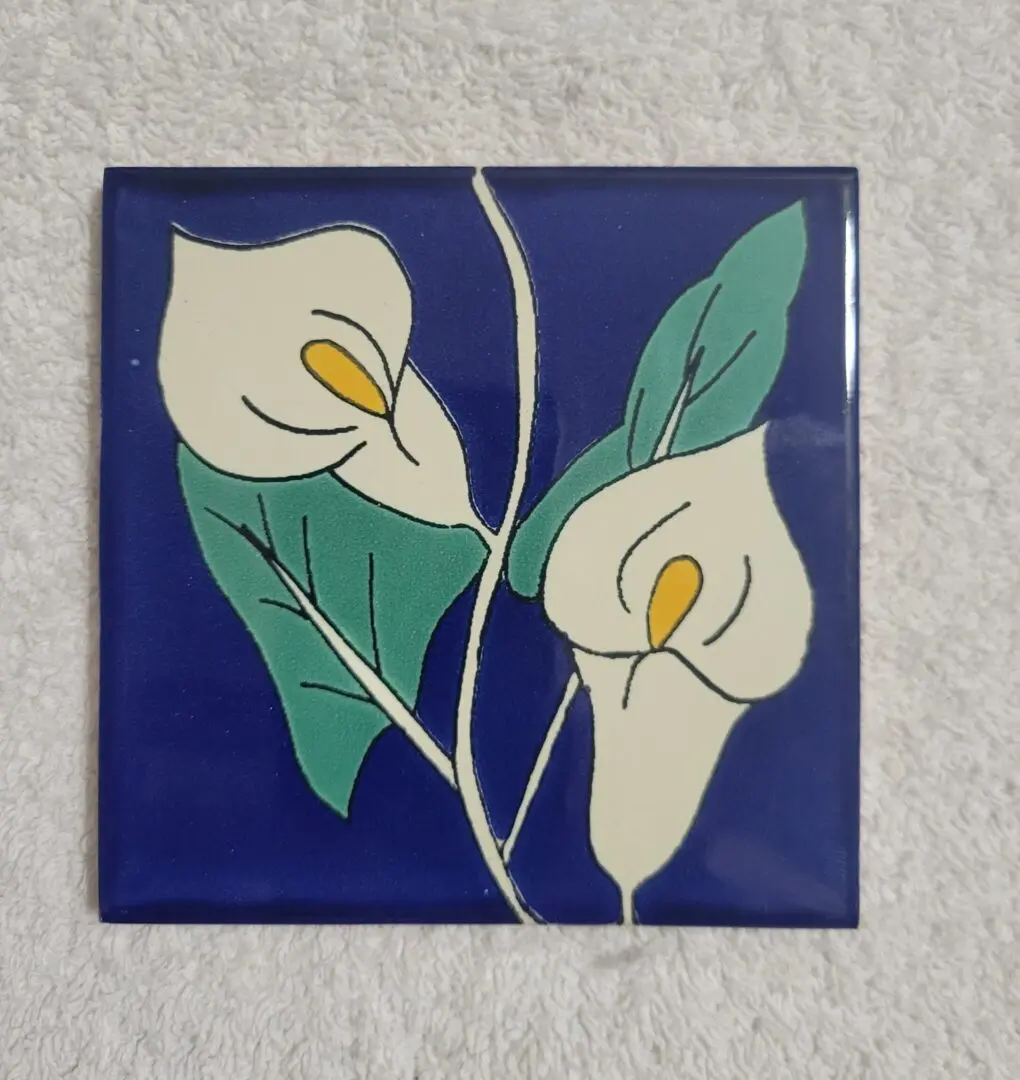 Floral tile with white lilies on blue.