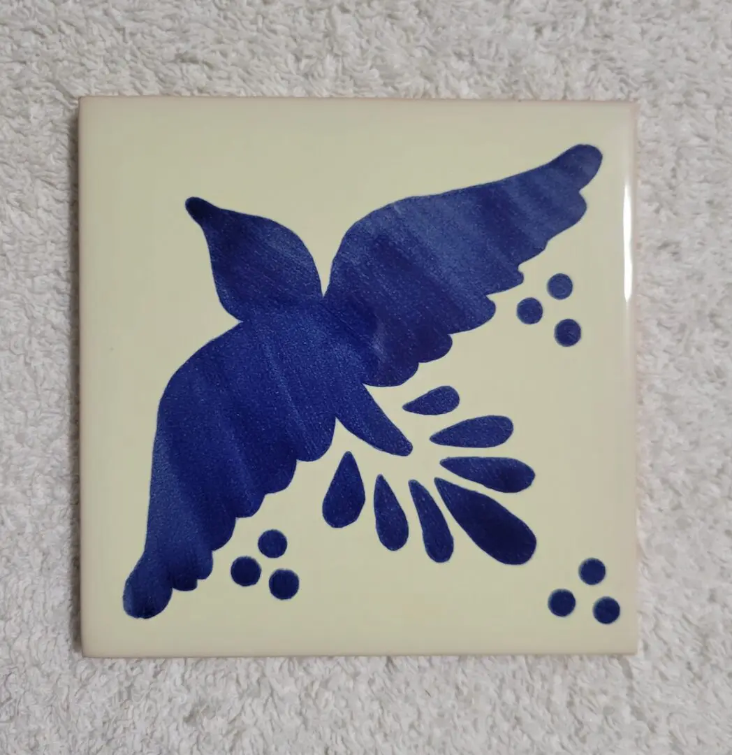 Blue bird design on ceramic tile.