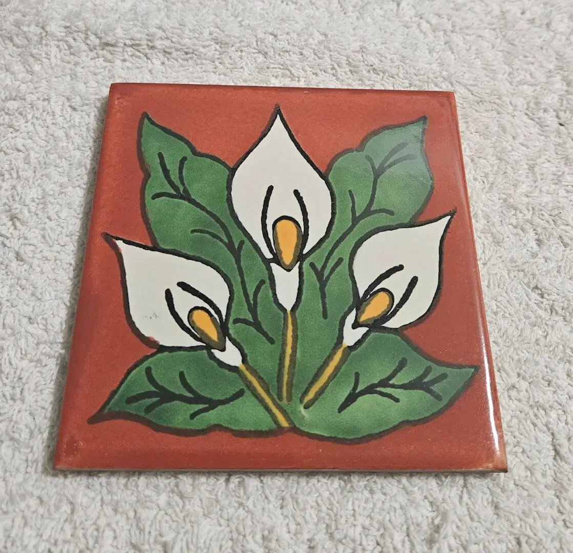 Tile with painted white calla lilies.
