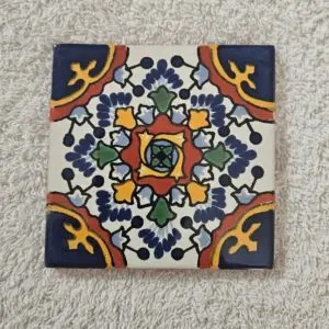 Colorful decorative ceramic tile with floral and geometric patterns.