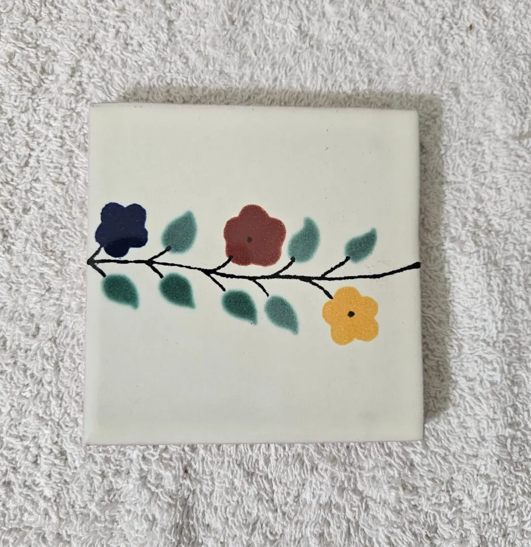 Tile with colorful floral design on towel.