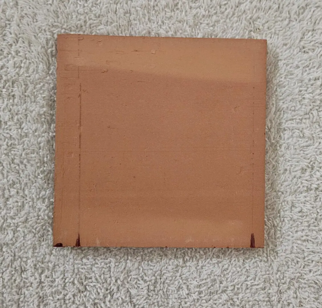 A folded brown paper bag on a textured carpet.