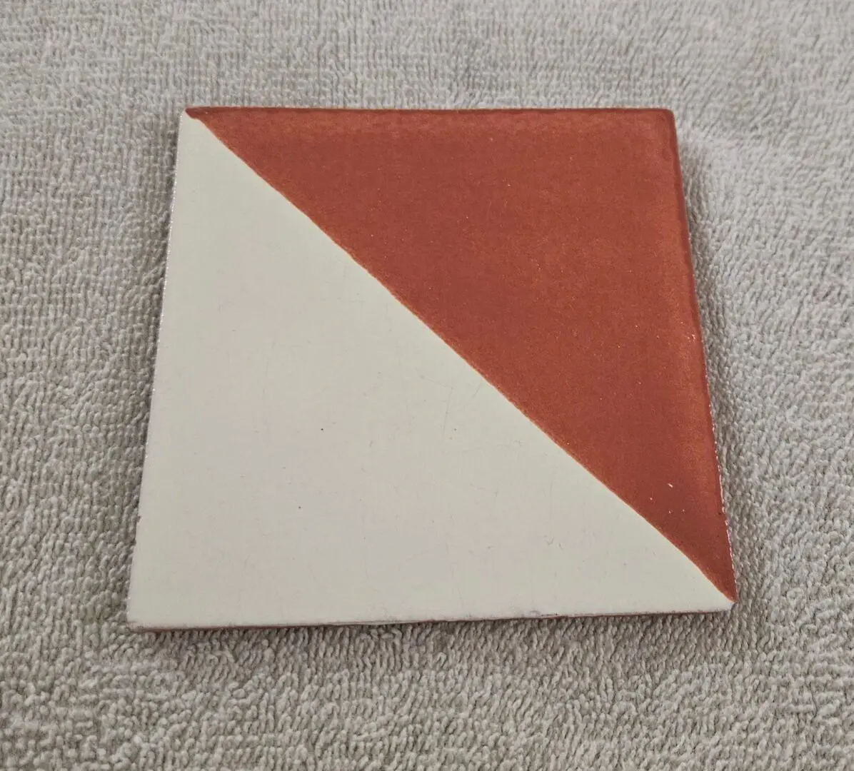 Square tile with red and white halves.