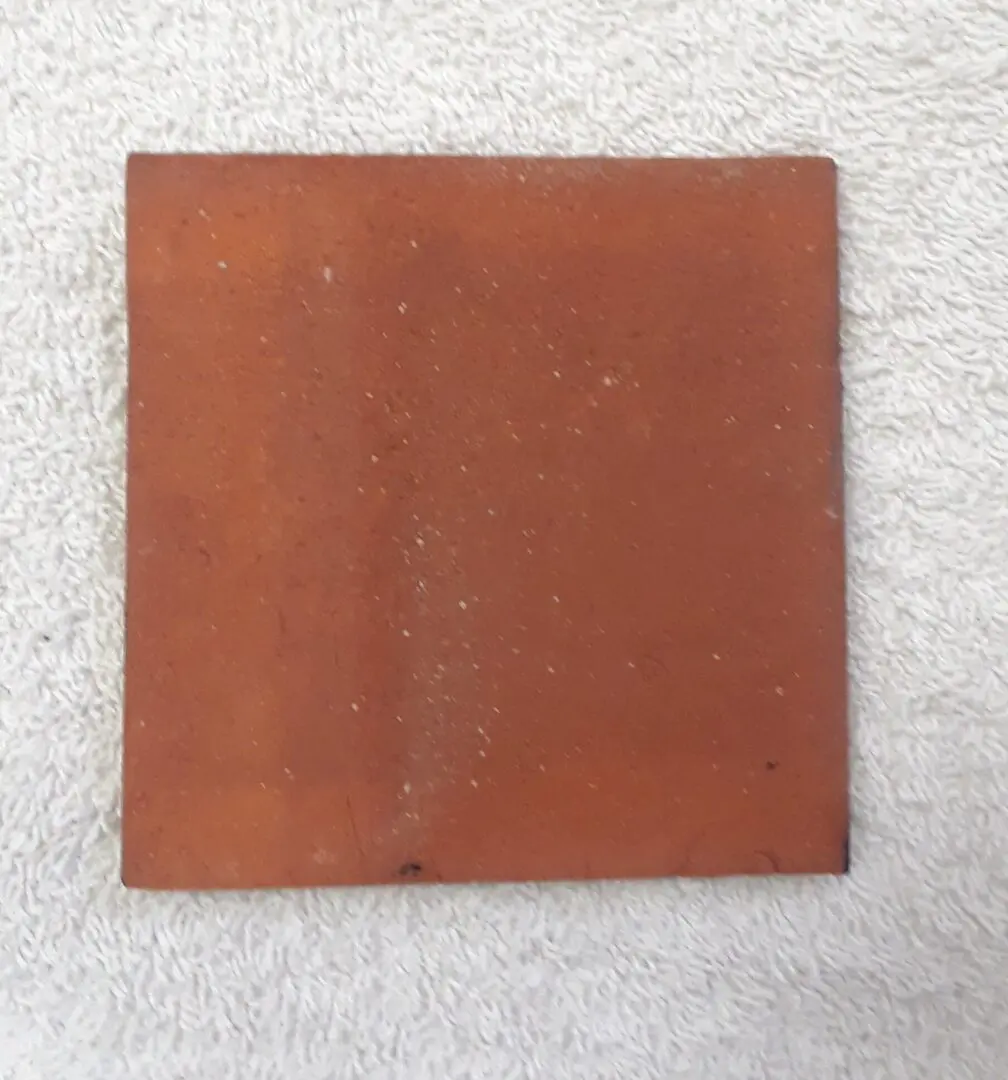 Red square tile on white background.