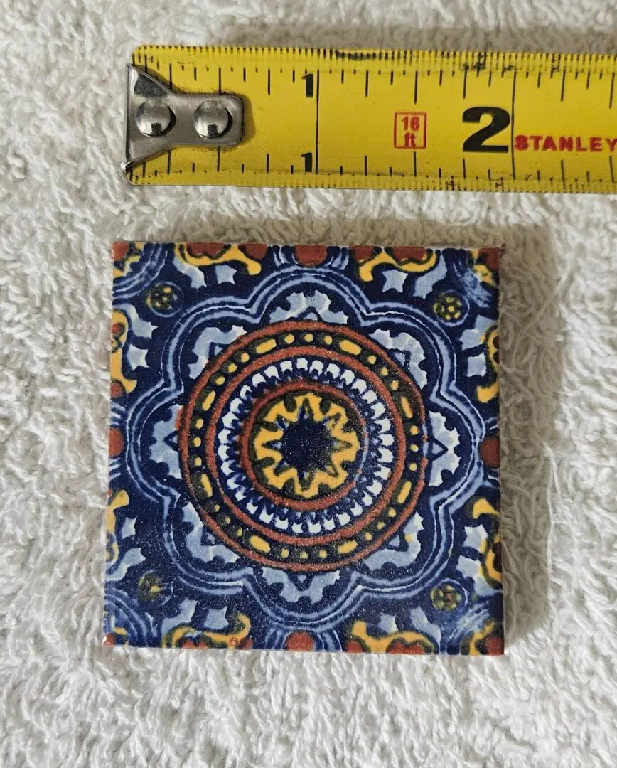Decorative tile with colorful circular pattern.