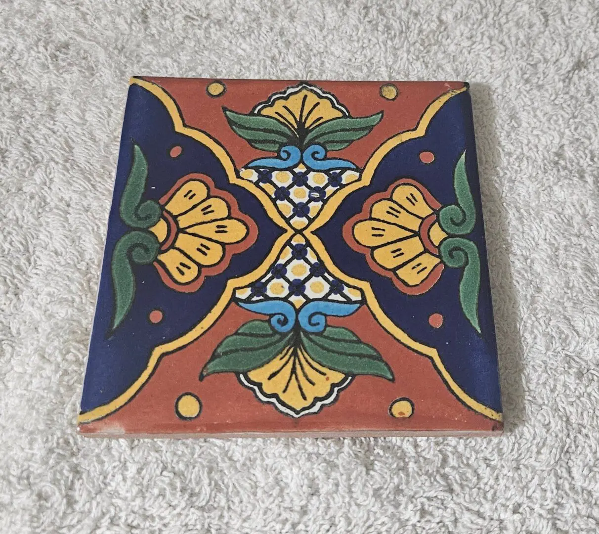 Hand-painted ceramic tile with floral pattern