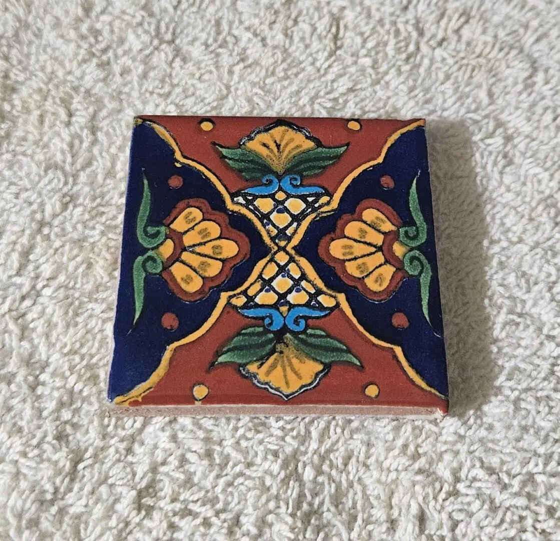 Decorative tile with floral geometric pattern.