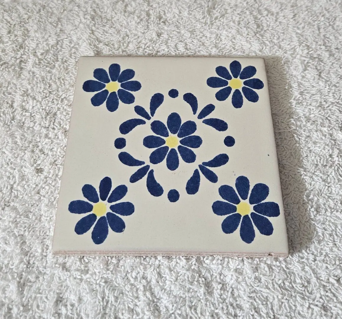 Tile with blue floral pattern design.