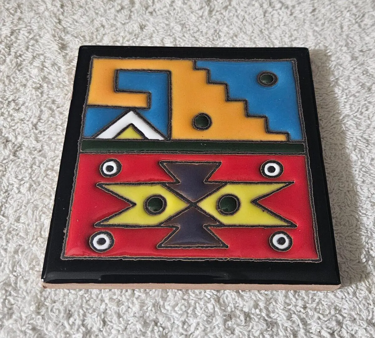 Colorful geometric ceramic tile with stepped design