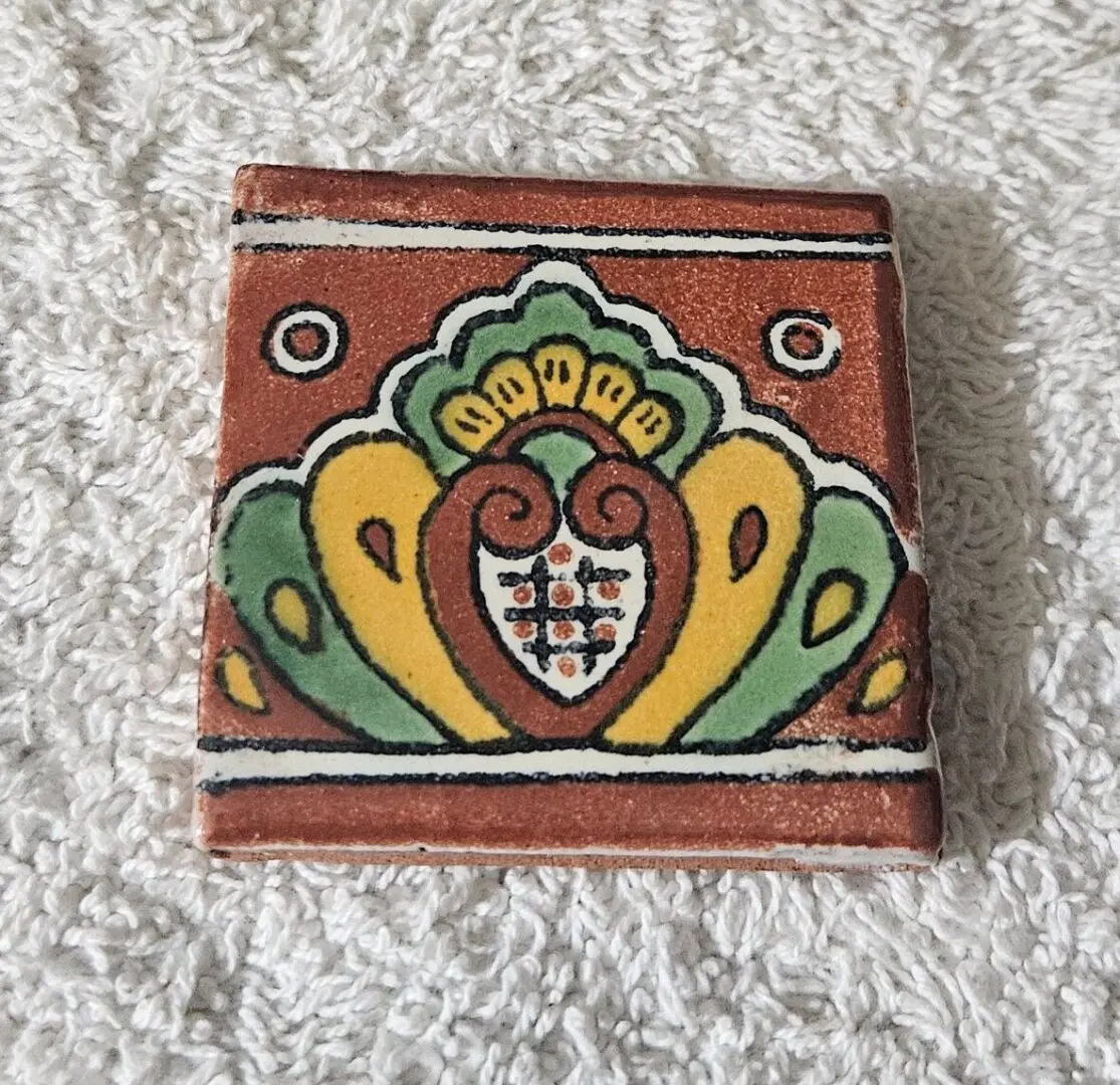 Hand-painted decorative ceramic tile with floral motif