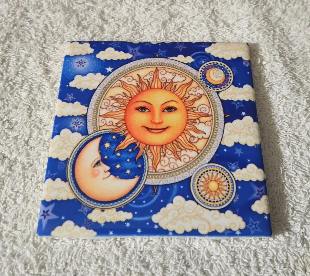 Sun and moon illustration with clouds.