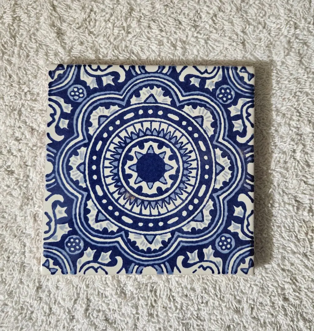 Blue and white decorative patterned ceramic tile.