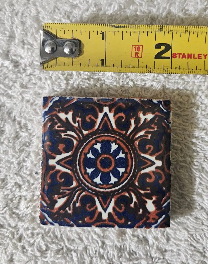 Small decorative blue and brown ceramic tile