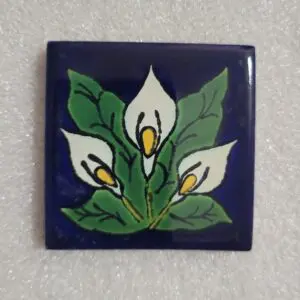 Decorative tile featuring white calla lilies and green leaves.