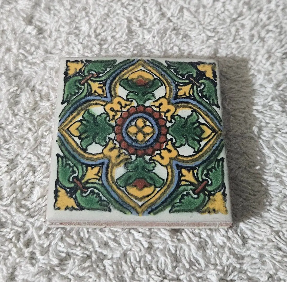 Hand-painted decorative ceramic tile with floral motif