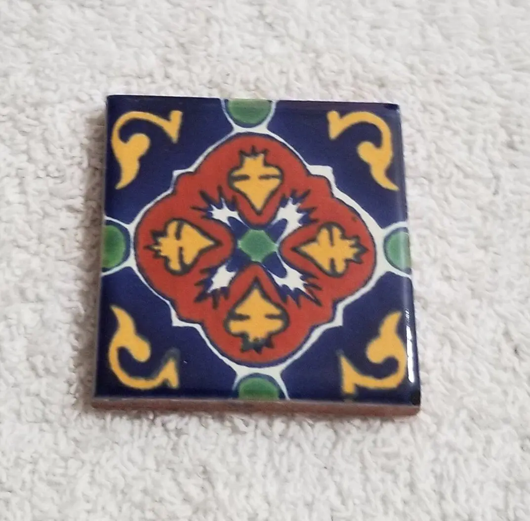Decorative ceramic tile with a colorful geometric pattern.
