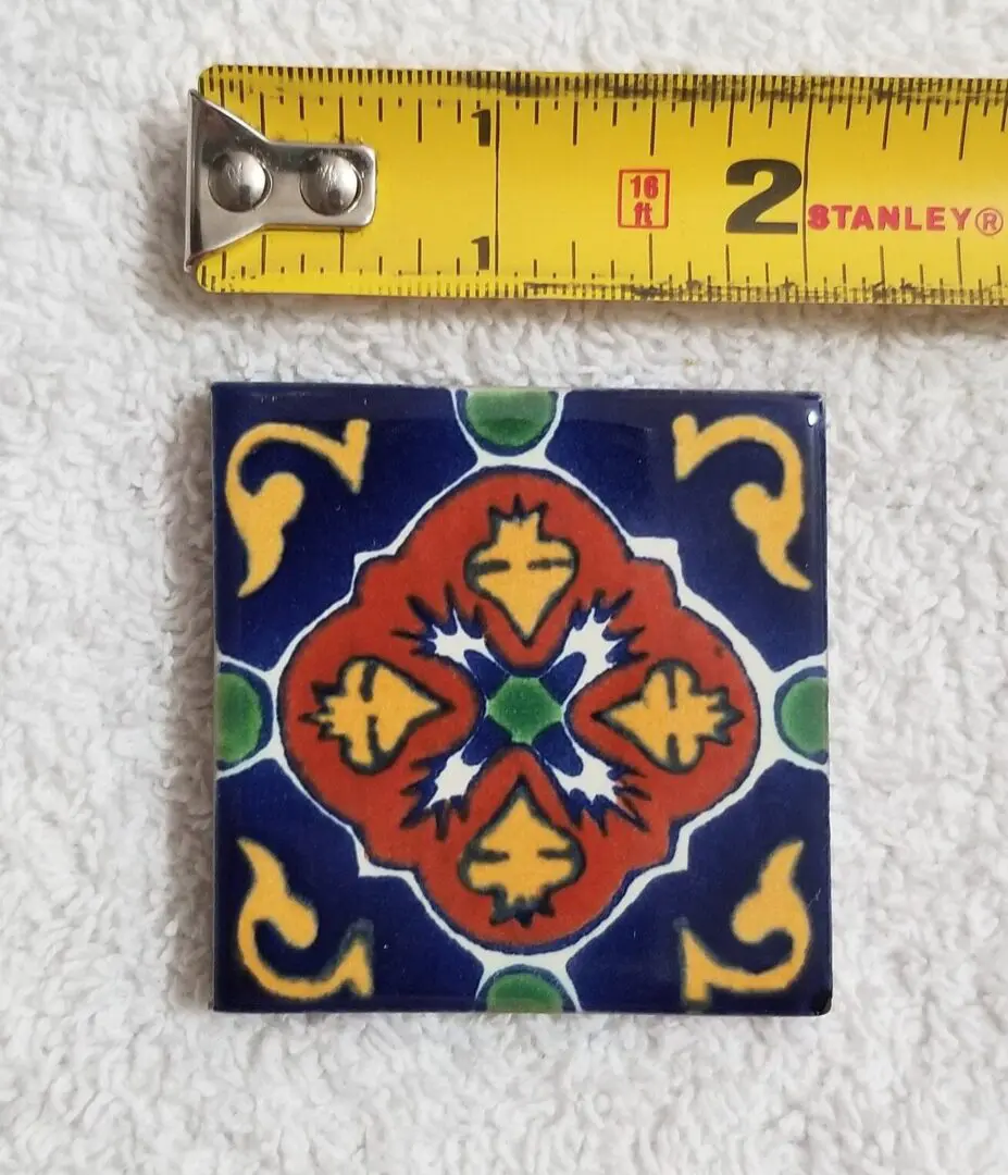 Colorful ceramic tile with ornate geometric and floral patterns.