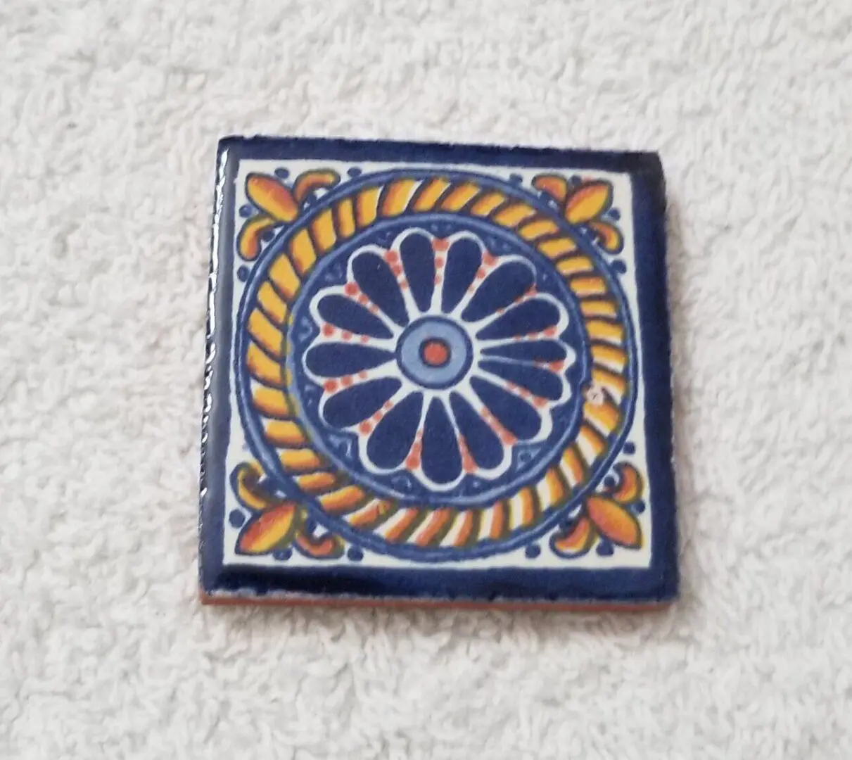 Hand-painted blue and yellow ceramic tile