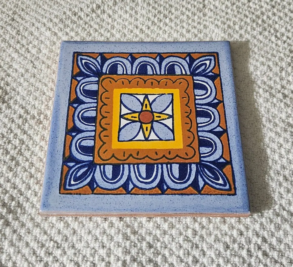 Colorful decorative tile with geometric pattern.