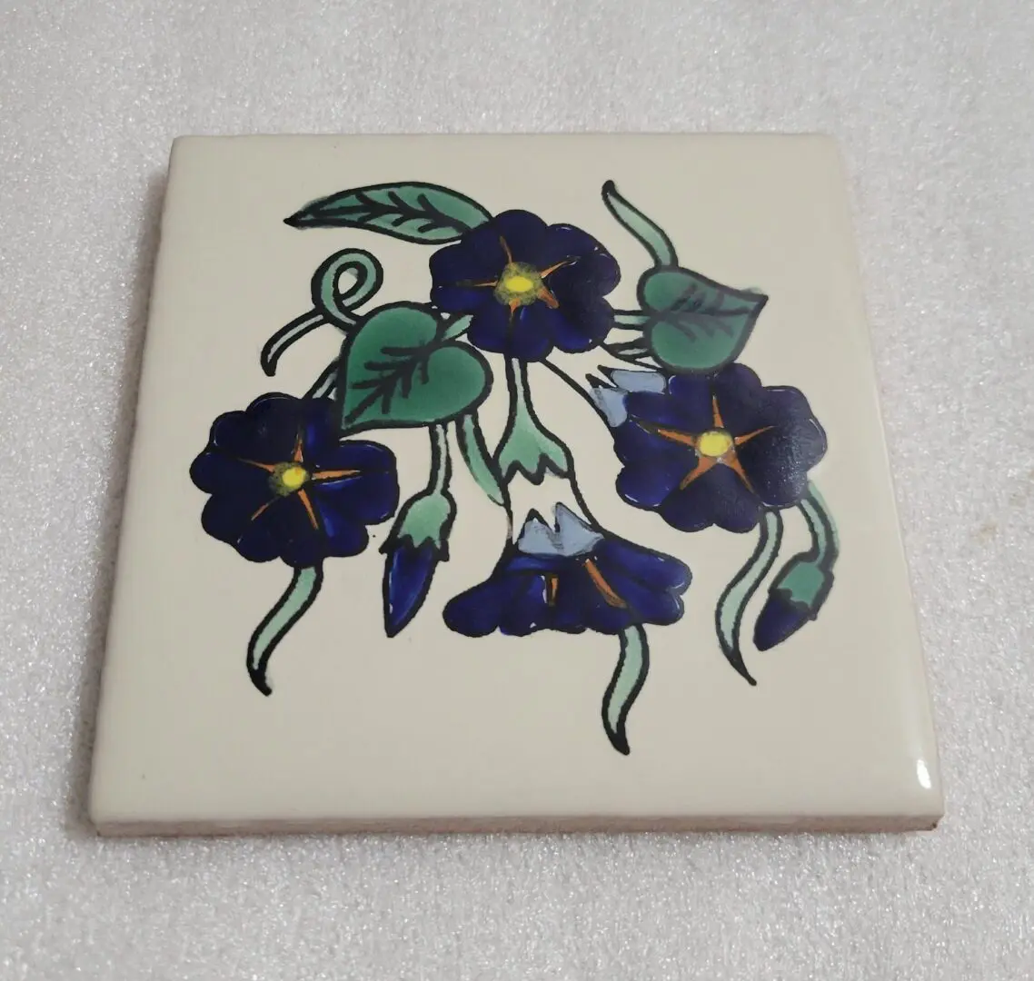 Ceramic tile with blue floral design.