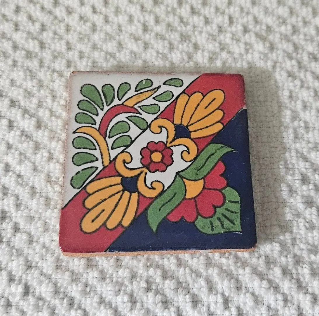 Square hand-painted tile with vibrant floral motif