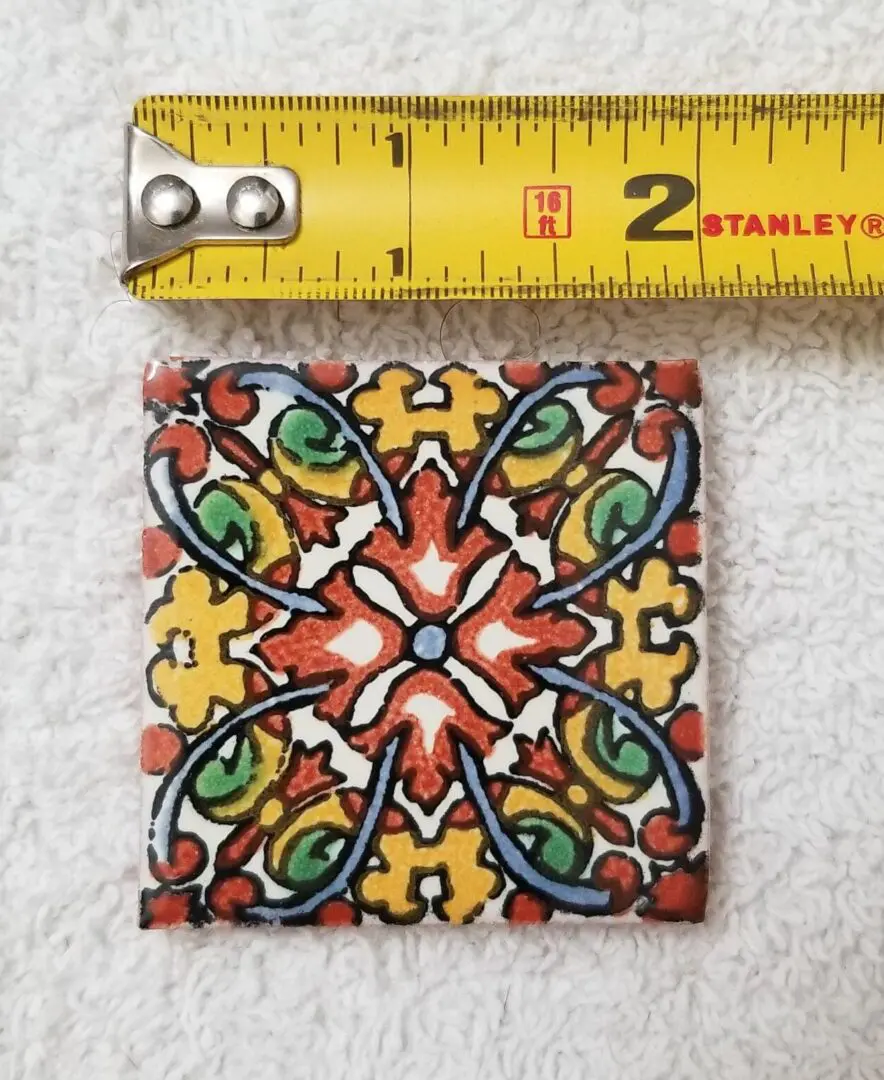 Colorful tile with measuring tape above.
