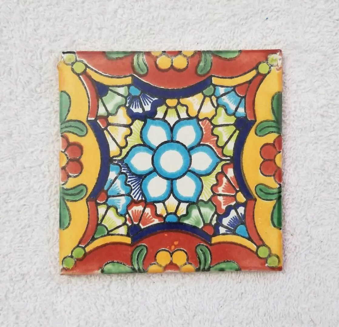 Colorful floral-patterned ceramic tile on display.