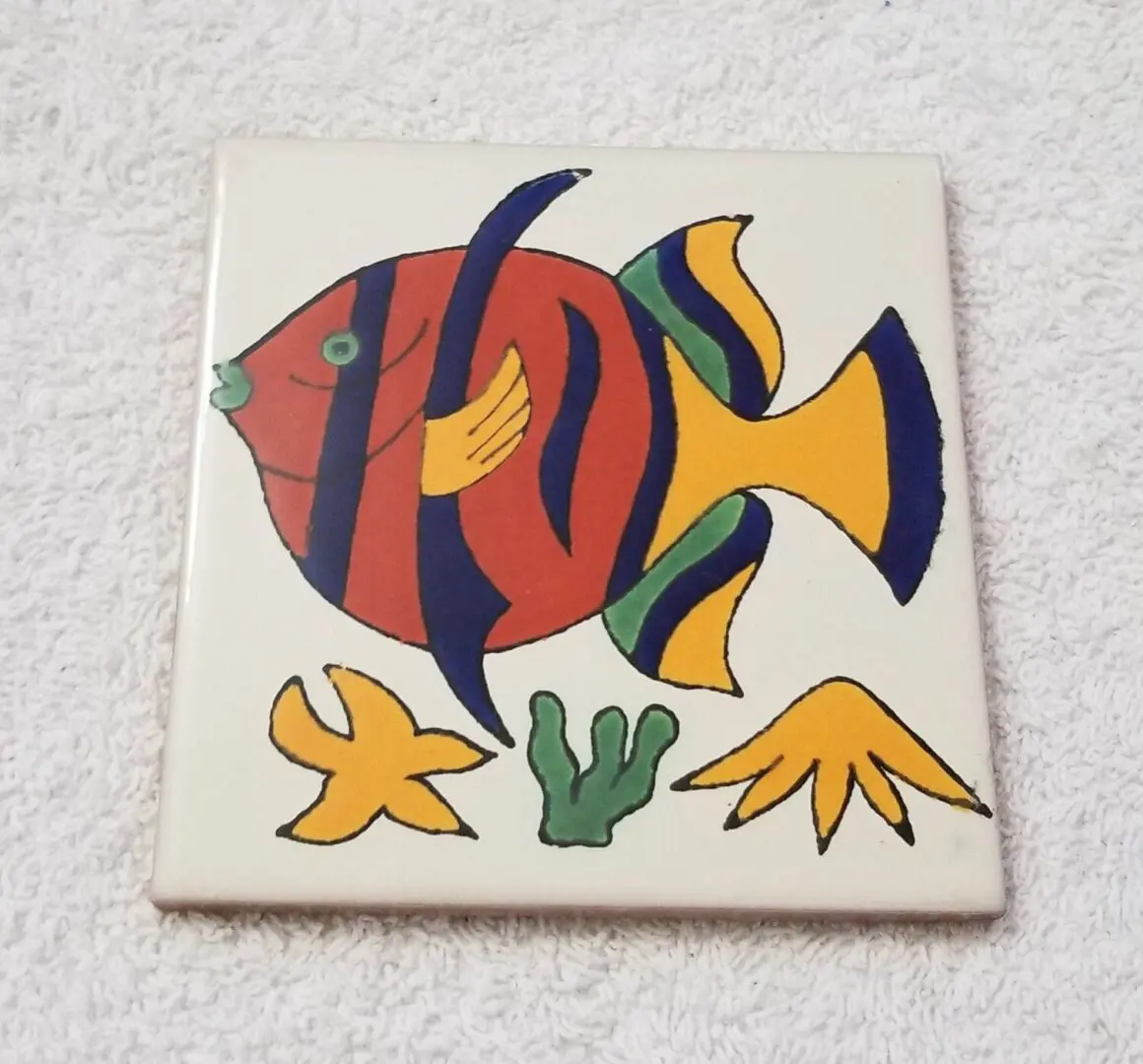 Colorful fish and sea plants on tile.
