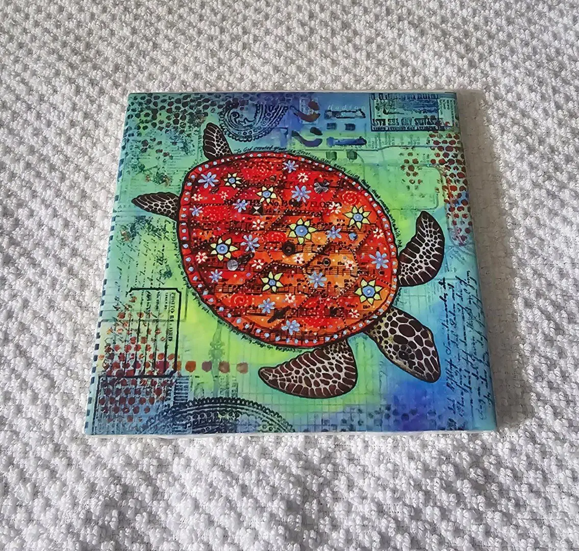 Colorful turtle art on textured surface.