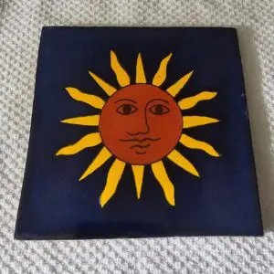 Sun face tile with yellow rays.